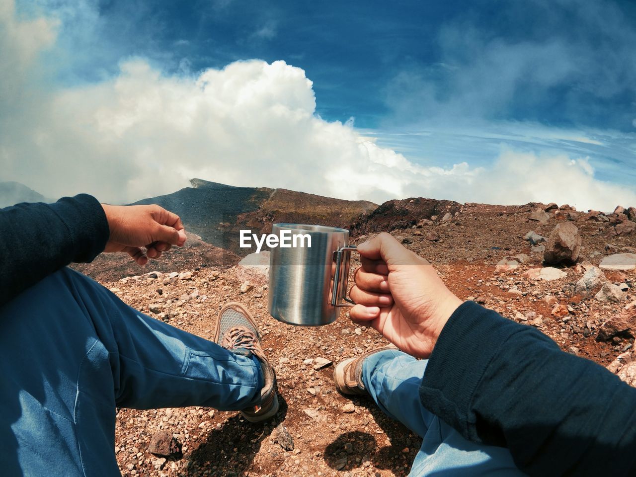 Midsection of man having food against sky