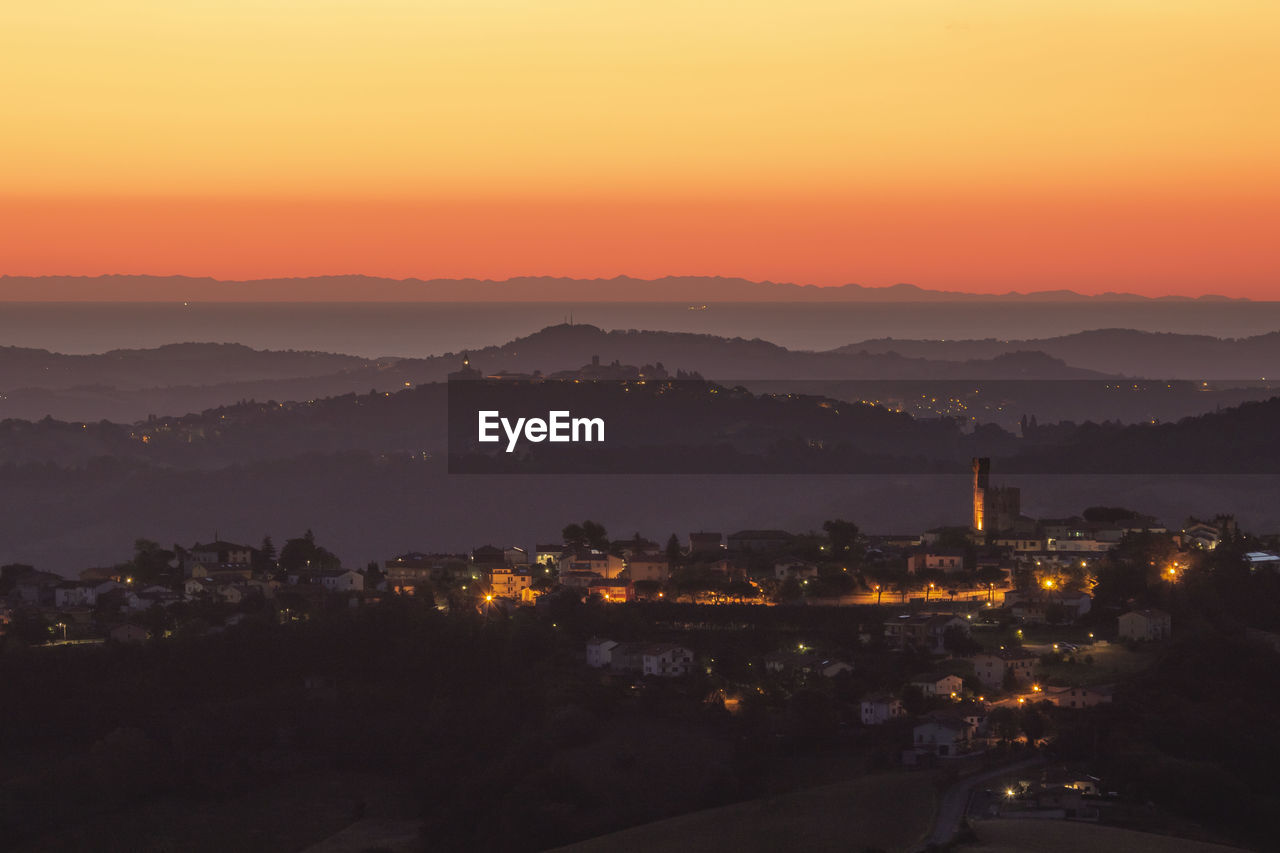 High angle view of illuminated cityscape against sky during sunrise