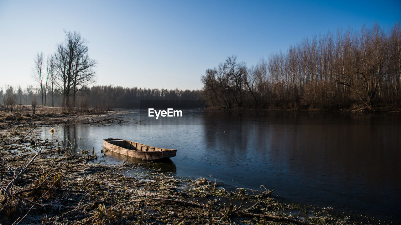 Scenic view of lake against sky during winter