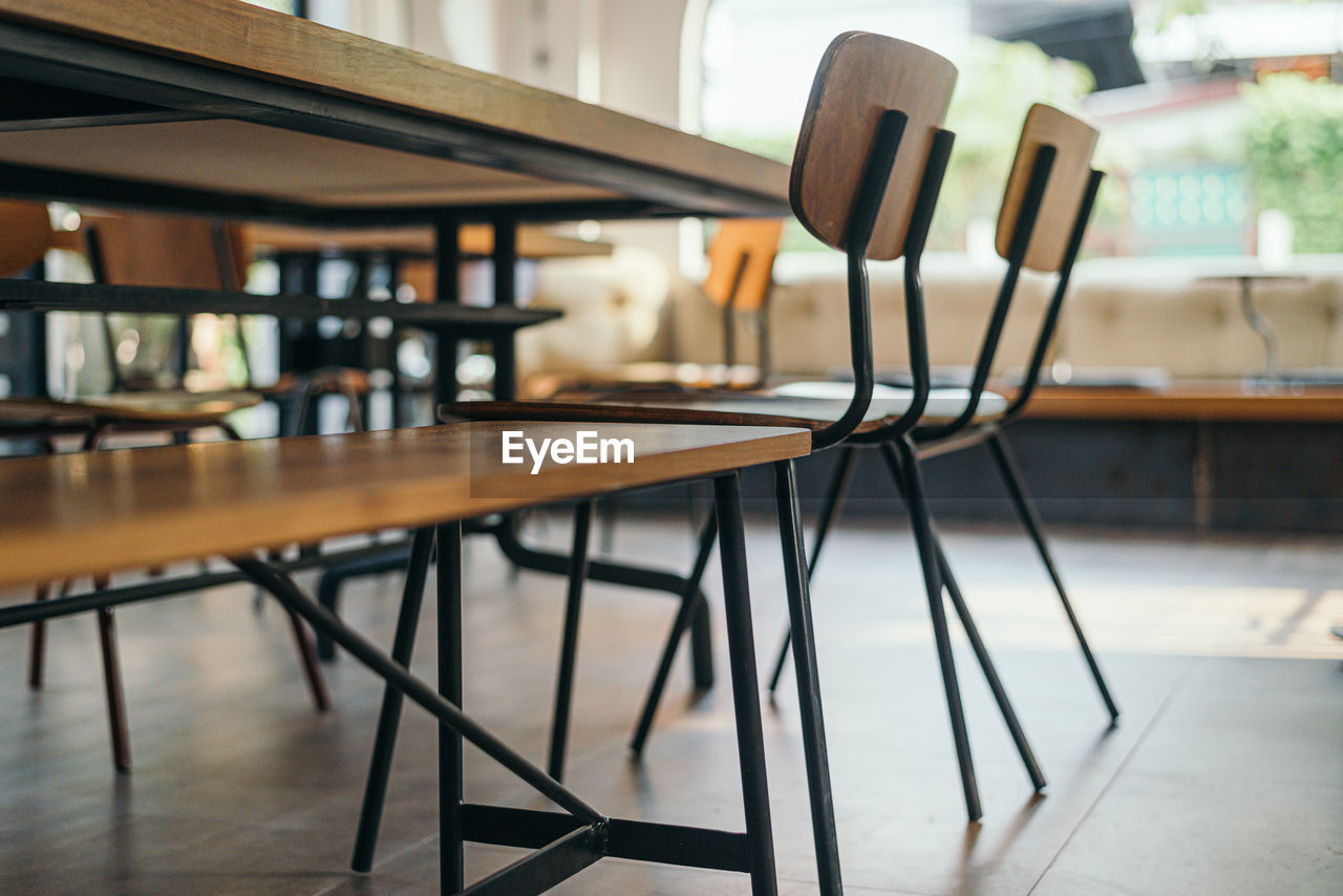 EMPTY CHAIRS AND TABLE IN RESTAURANT