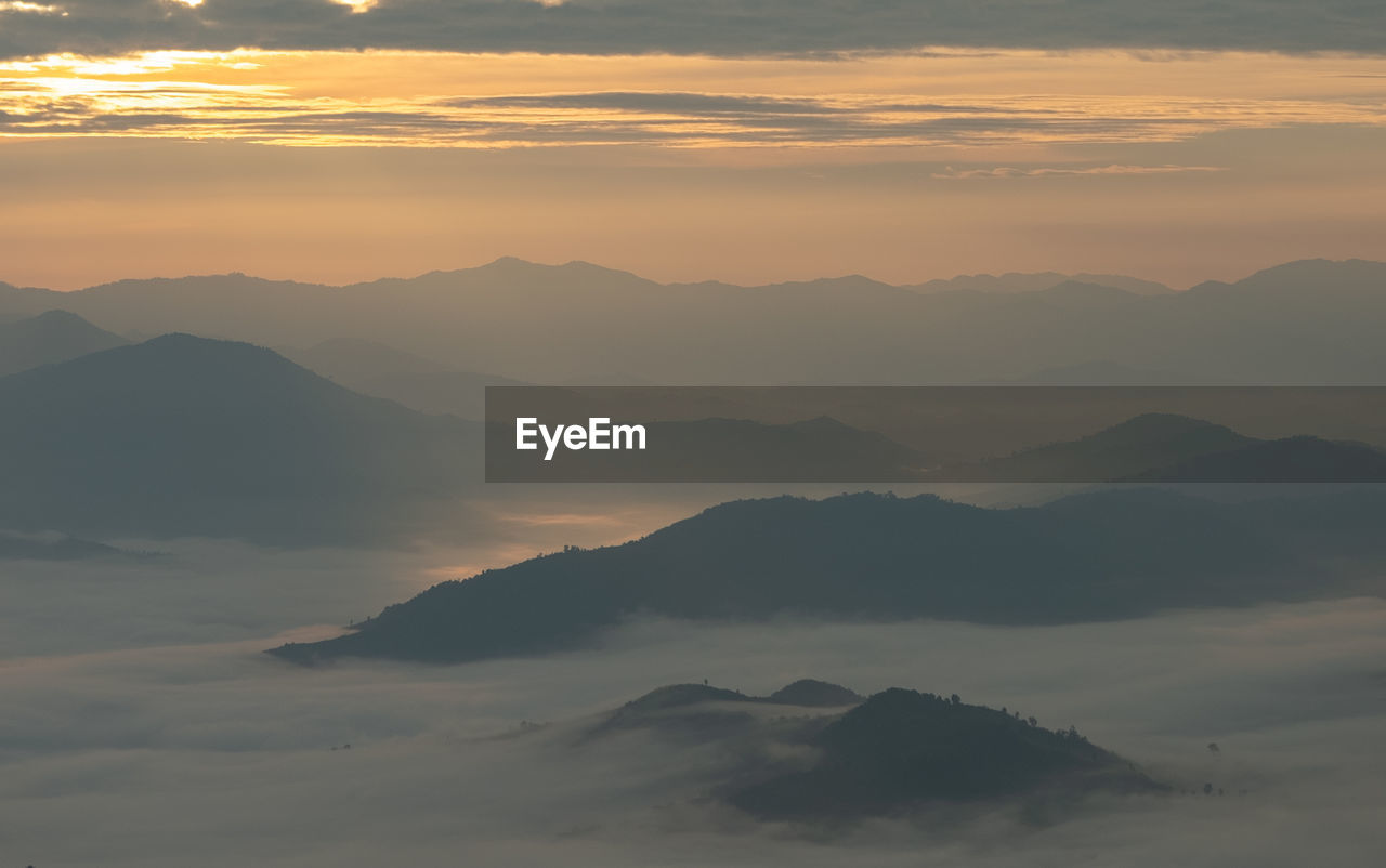 Scenic view of mountains and cloudscape during sunset