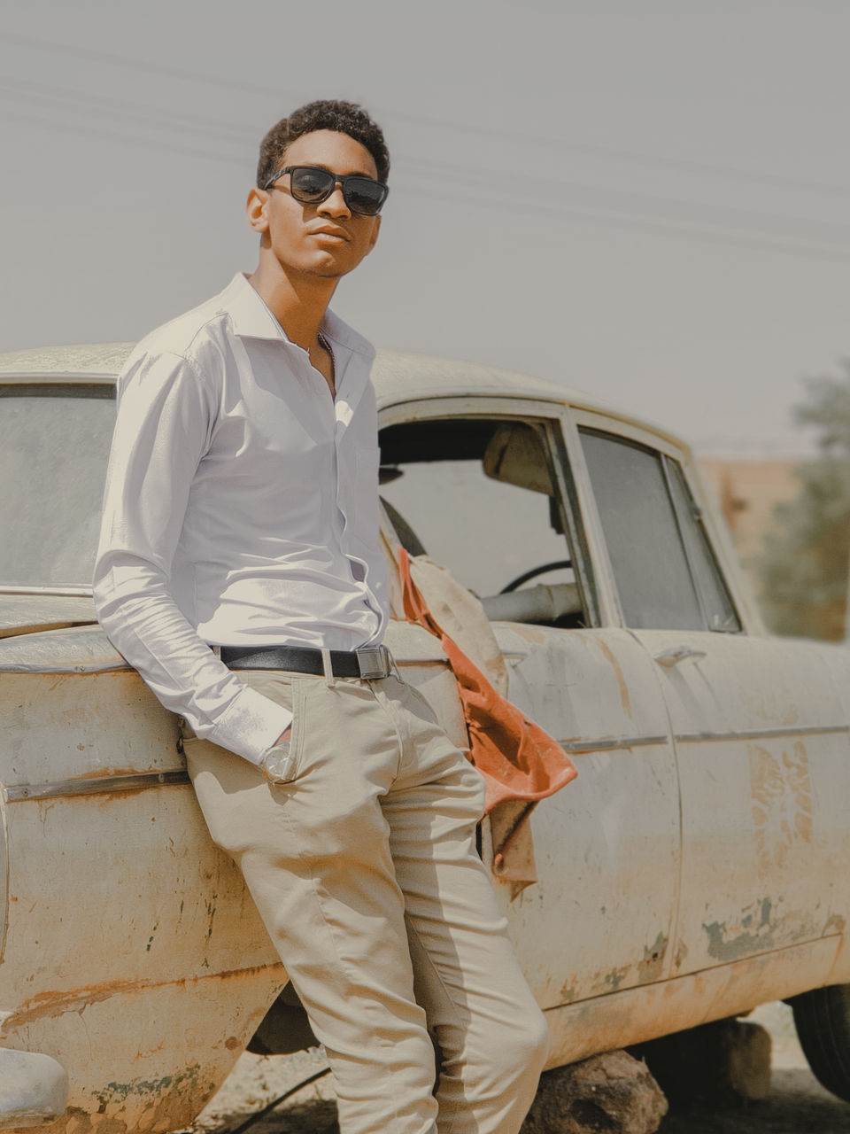 Portrait of young man wearing sunglasses standing outdoors