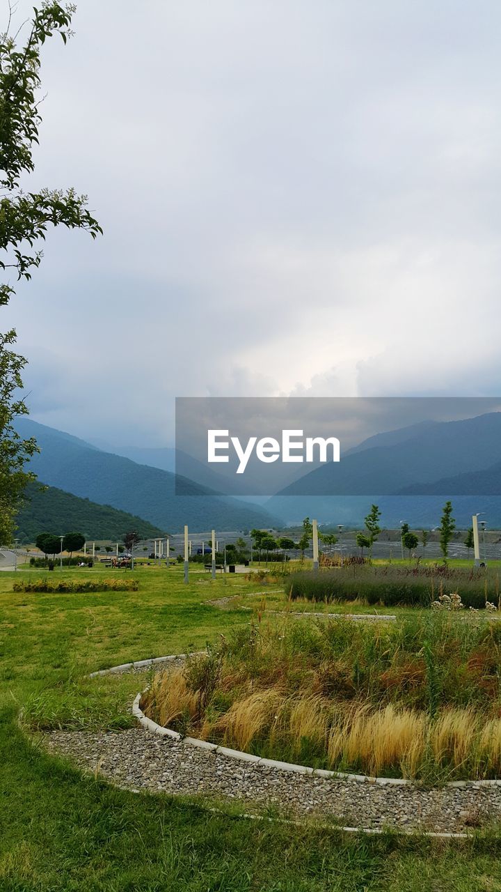 View of fields against cloudy sky