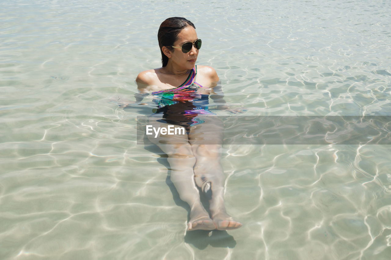 Full length of woman swimming in the sea