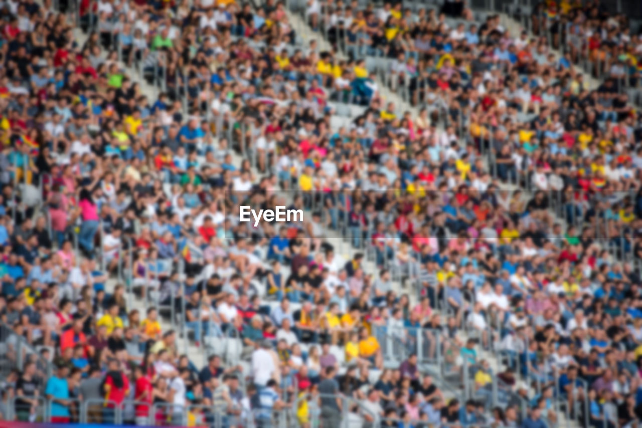 Defocused image of people sitting in stadium