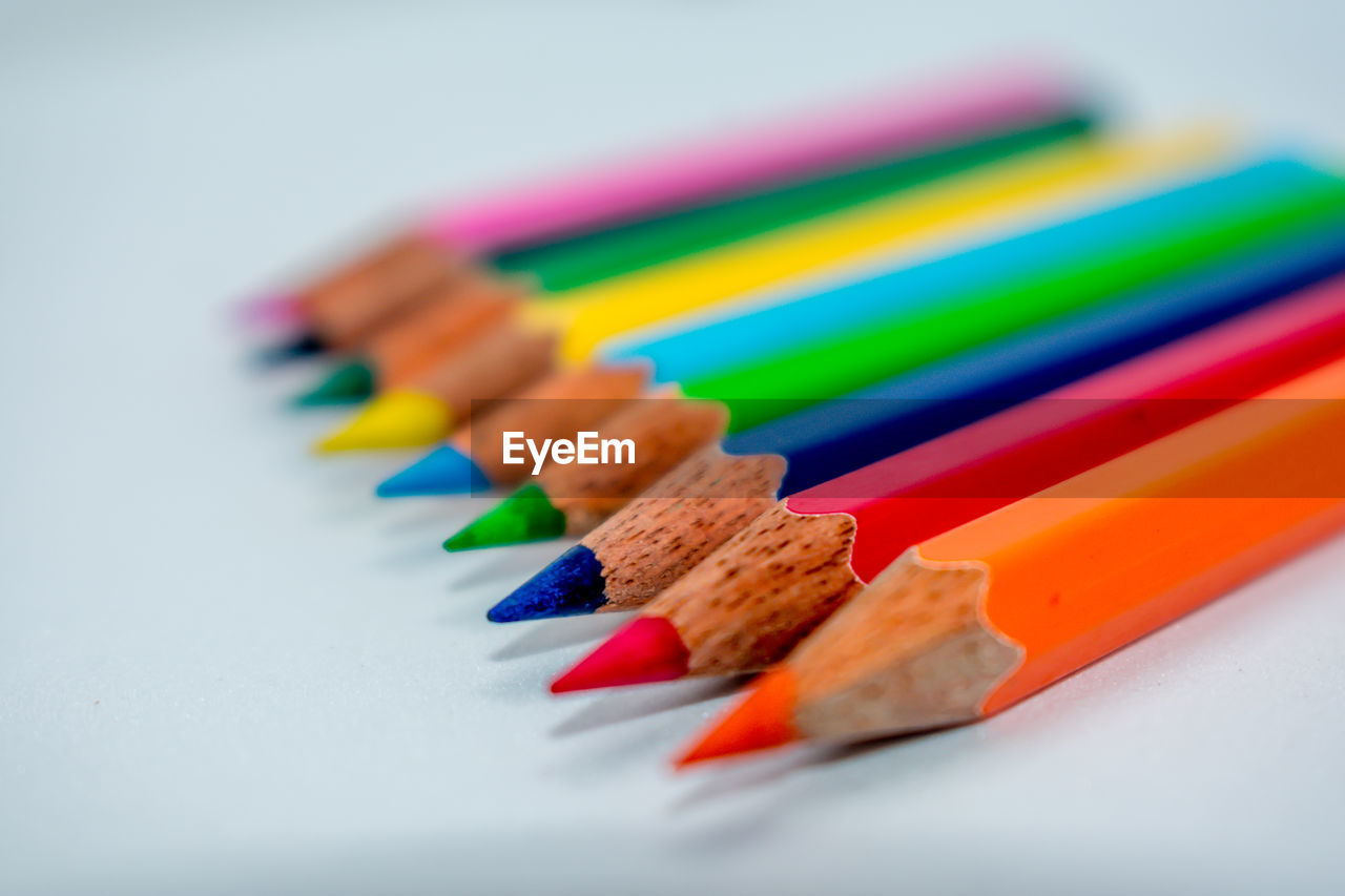 Close-up of colored pencils against gray background