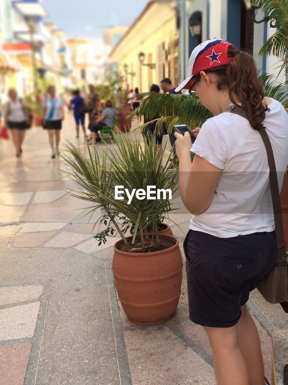 WOMAN STANDING IN FRONT OF CITY