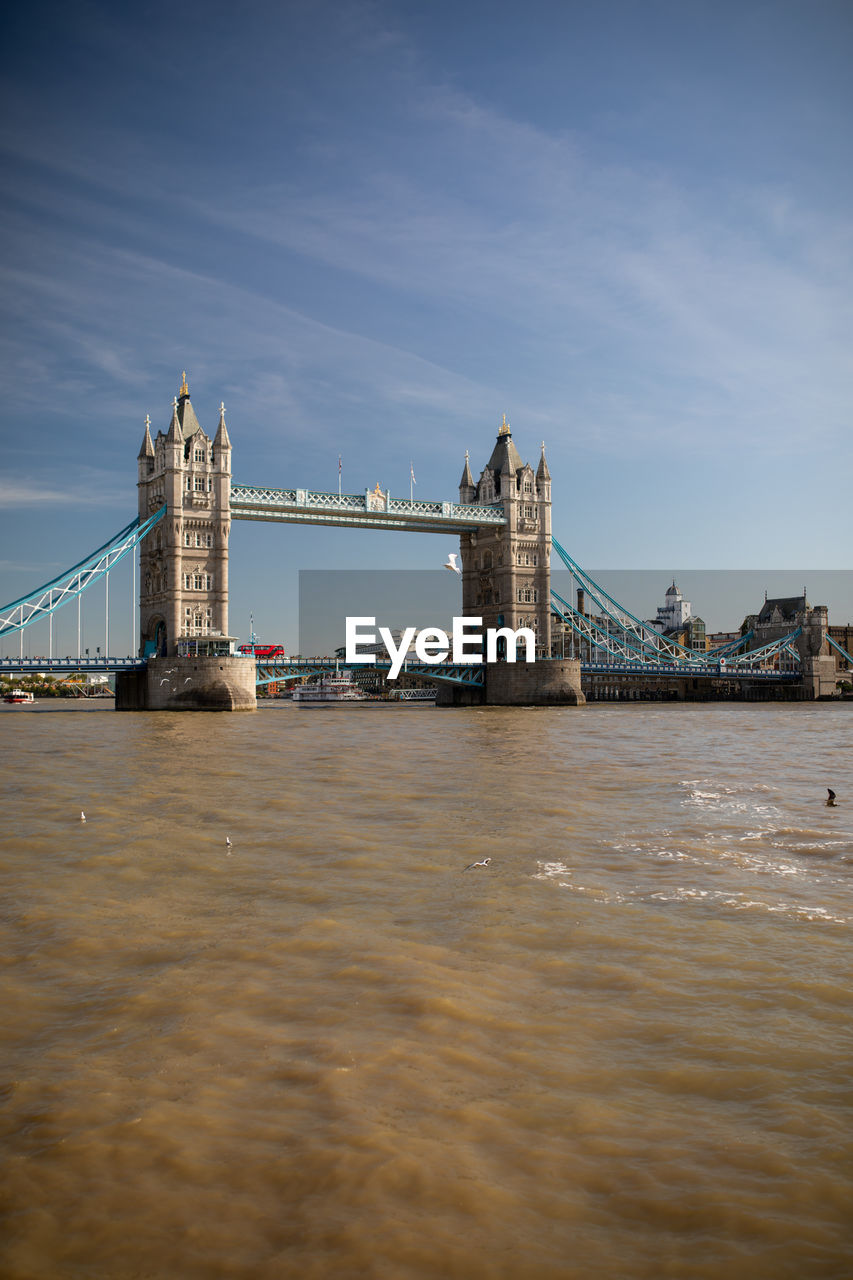 Bridge over river with buildings in background