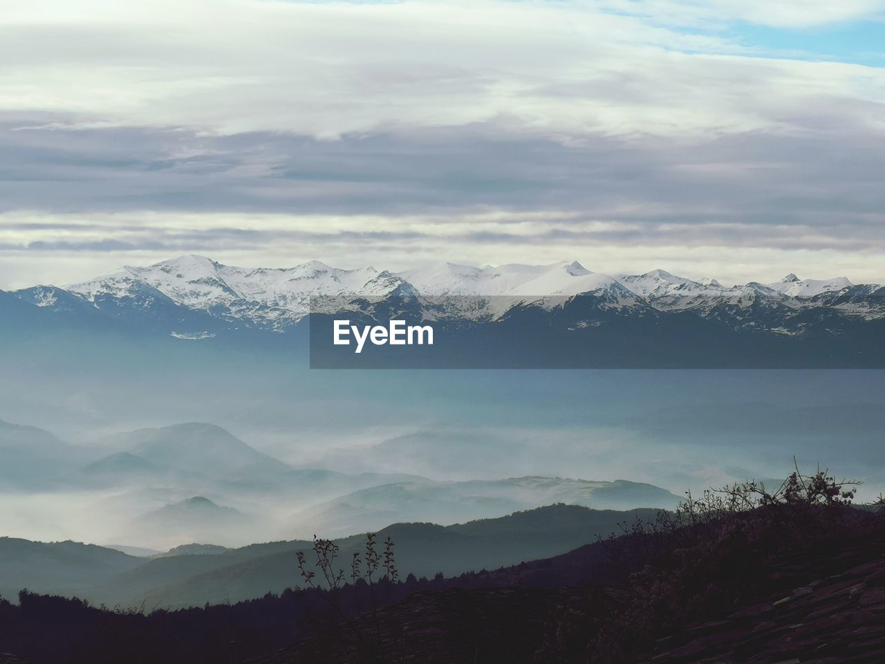 Scenic view of snowcapped mountains against sky