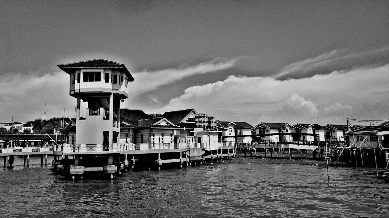 Built structure in water against sky