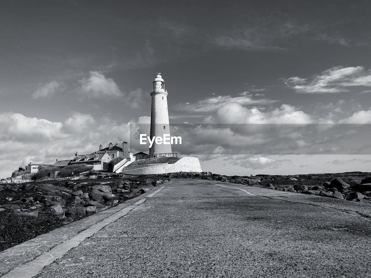 Lighthouse amidst buildings against sky