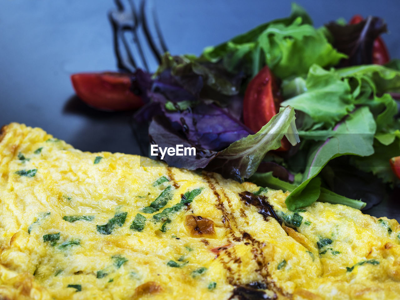 High angle close-up of omelet with vegetables served in plate
