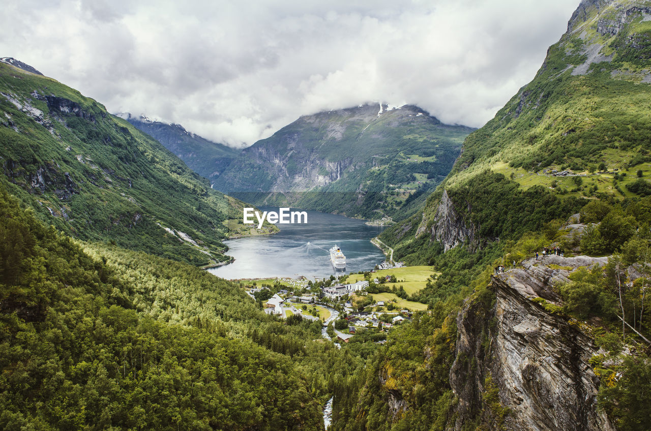 Scenic view of river amidst mountains against sky