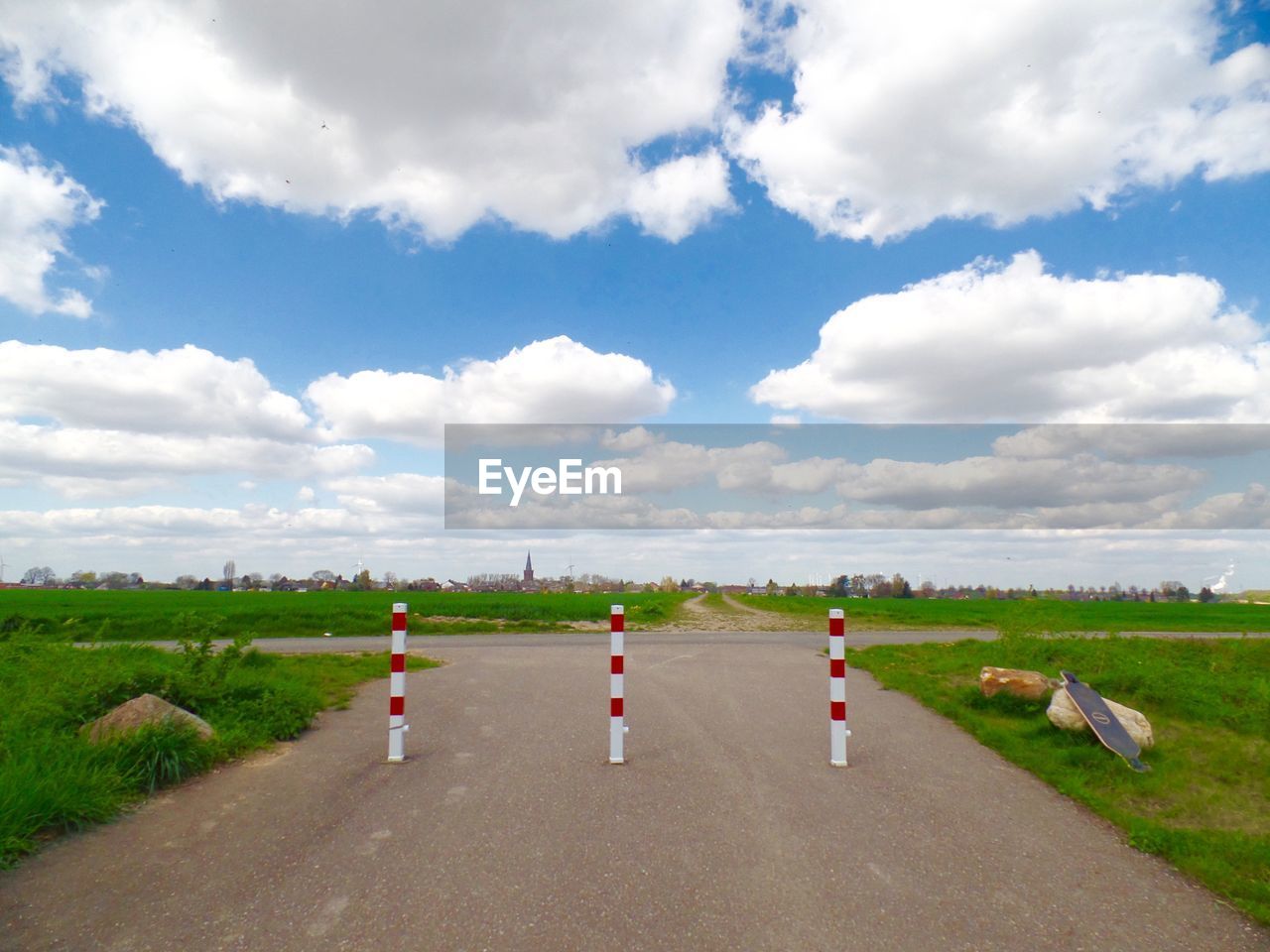 People on countryside landscape against cloudy sky