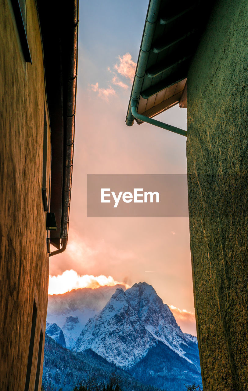 Low angle view of snow covered mountain against sky