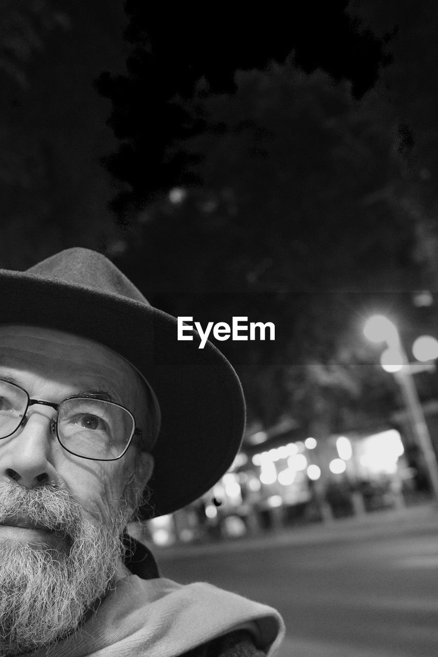 hat, one person, black, adult, glasses, facial hair, beard, portrait, eyeglasses, white, men, black and white, headshot, fedora, monochrome photography, monochrome, clothing, night, person, sun hat, lifestyles, focus on foreground, looking, fashion accessory, darkness, city, street, senior adult, mature adult, front view, outdoors, nature, sky, human face, looking away, leisure activity, vision care, cap, contemplation