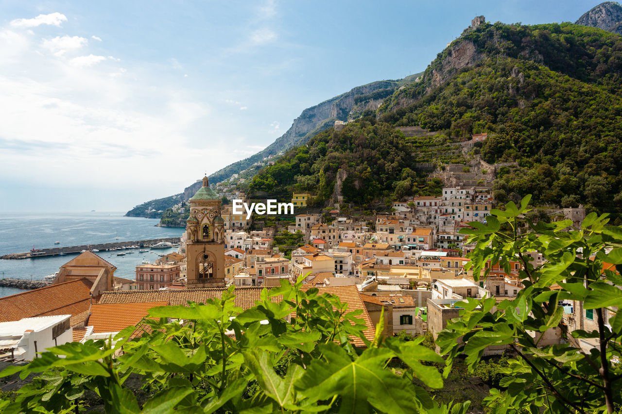 Townscape by sea against sky