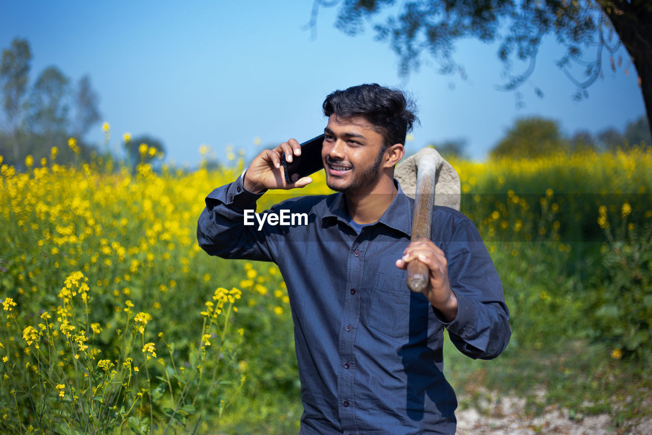 MAN STANDING ON FIELD