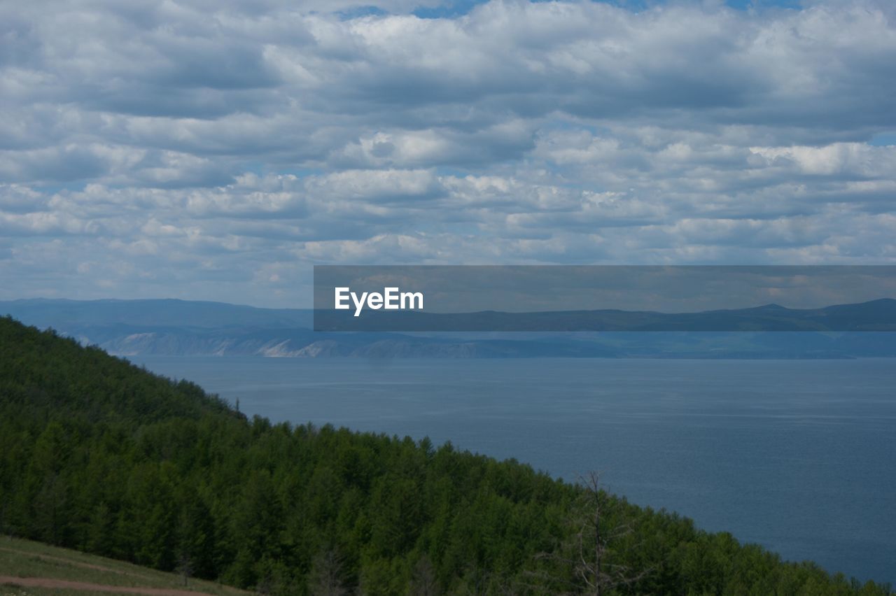 Scenic view of mountains against cloudy sky