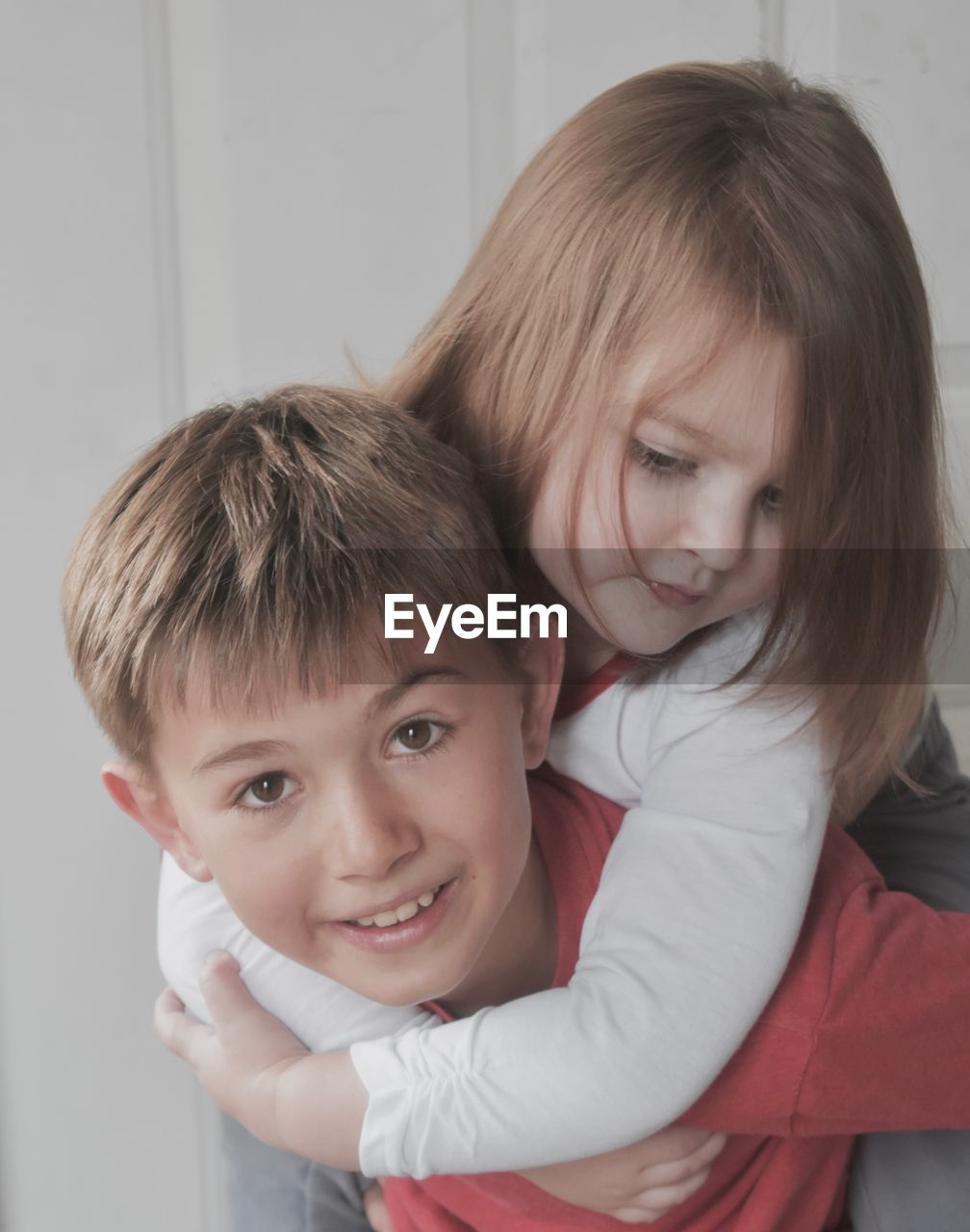 Portrait of brother carrying sister