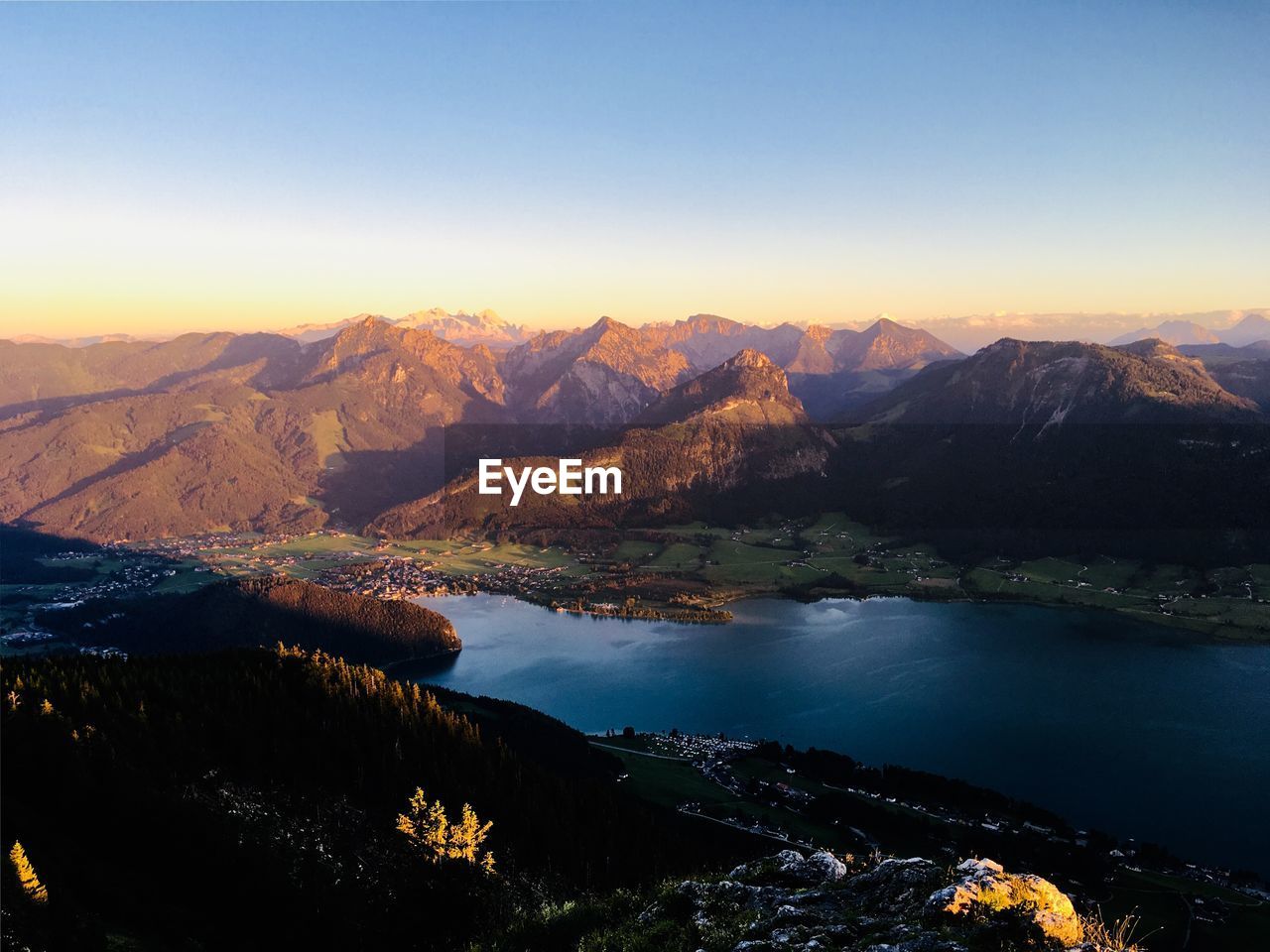 SCENIC VIEW OF LAKE WITH MOUNTAIN RANGE IN BACKGROUND