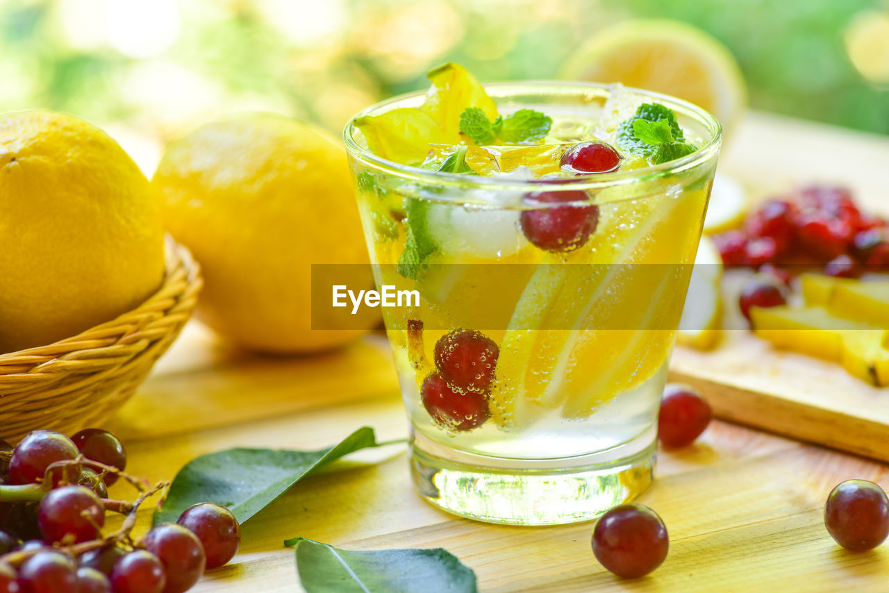 food and drink, food, fruit, healthy eating, freshness, wellbeing, refreshment, drink, citrus fruit, plant, drinking glass, produce, soft drink, household equipment, glass, leaf, berry, summer, no people, wood, herb, dish, sweet food, lemon, nature, plant part, table