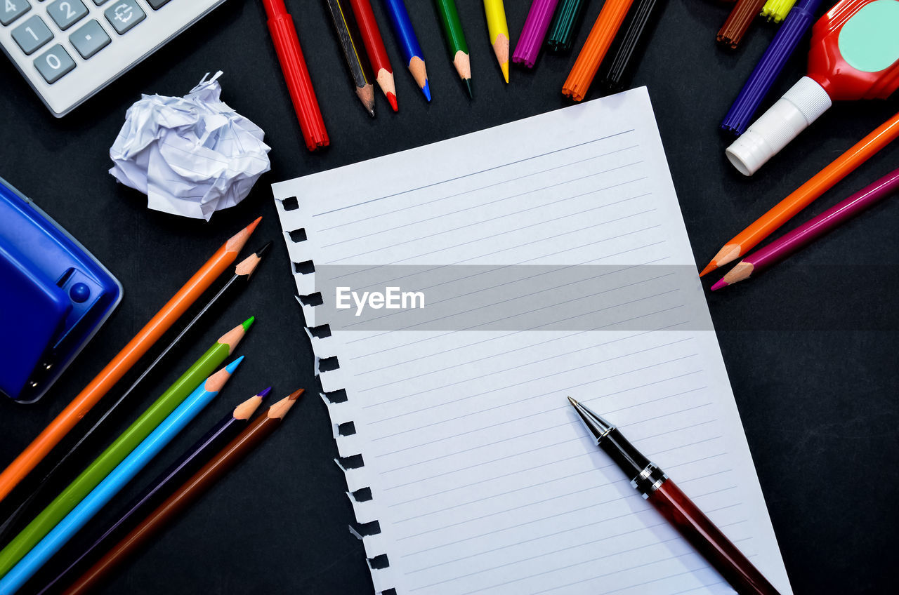 High angle view of school supplies on table