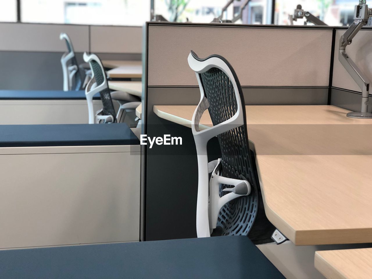 CLOSE-UP OF SHOES ON TABLE BY EMPTY SEATS