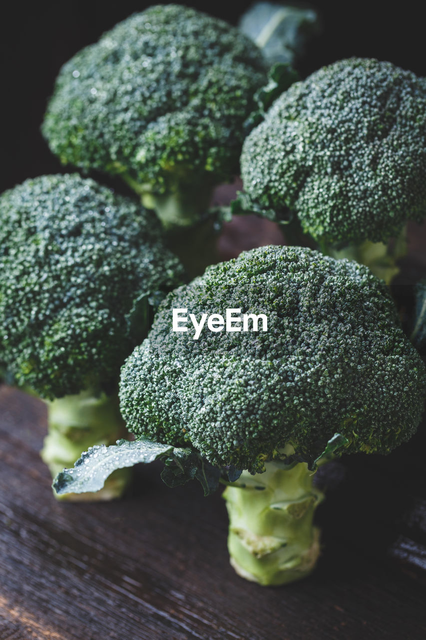 Close-up of broccolis on wooden table