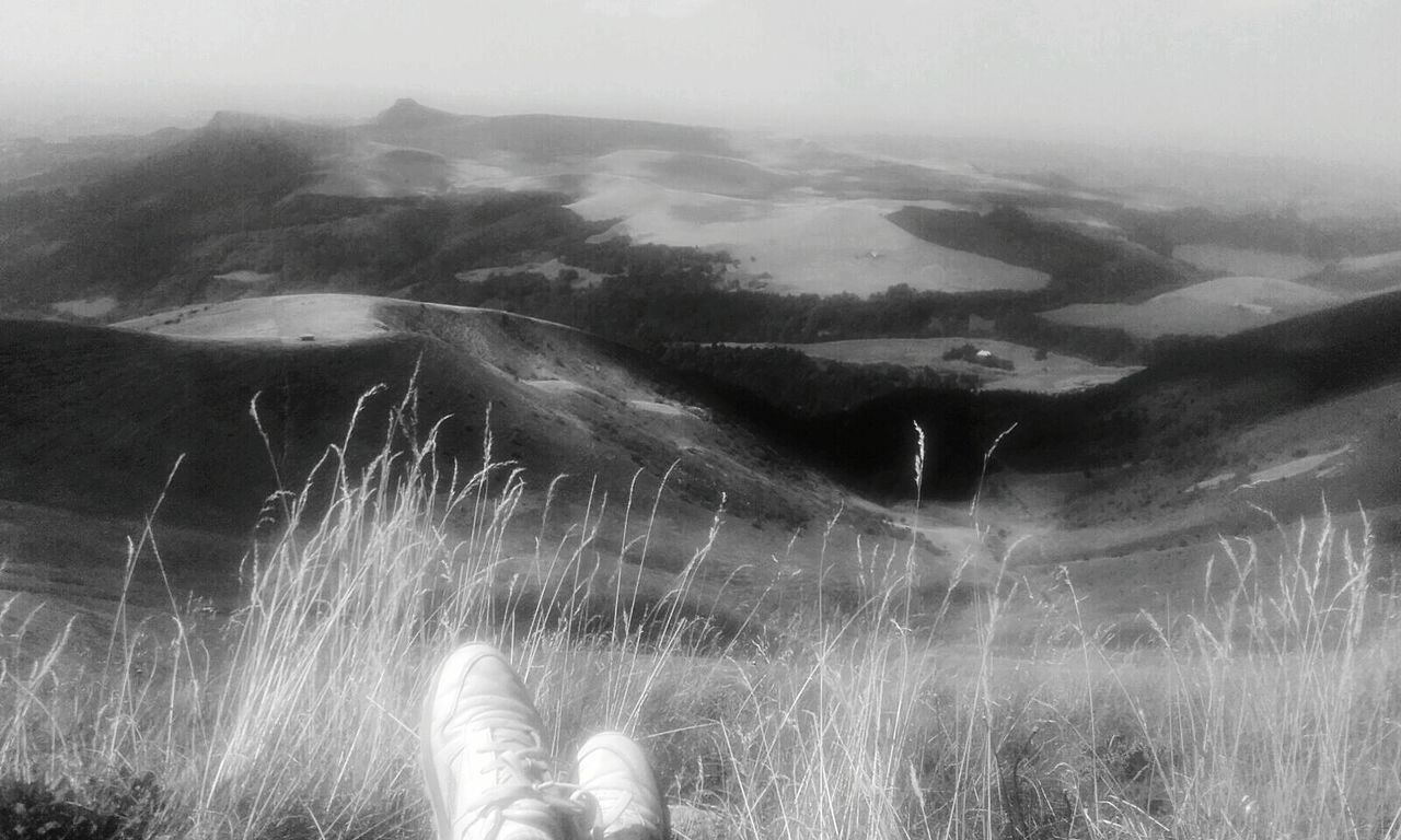 PERSON STANDING ON MOUNTAIN