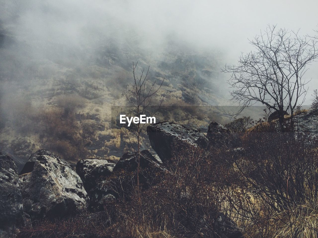 High angle view of rock formations on himalayas during foggy weather