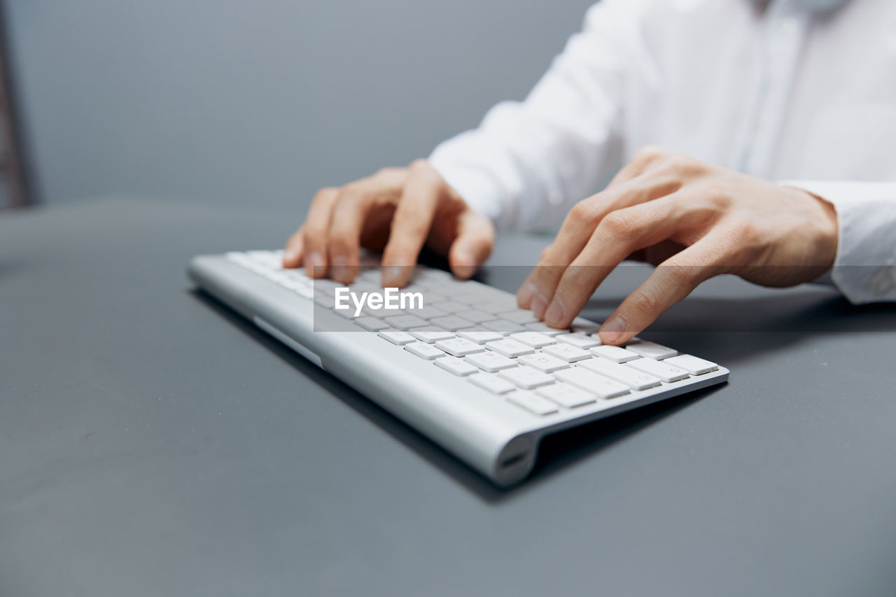 Midsection of woman using laptop on table