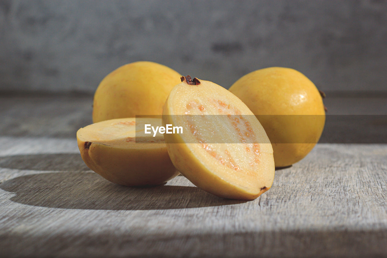 Yellow guava on wooden background. vitamin c, healthy fruit diet.