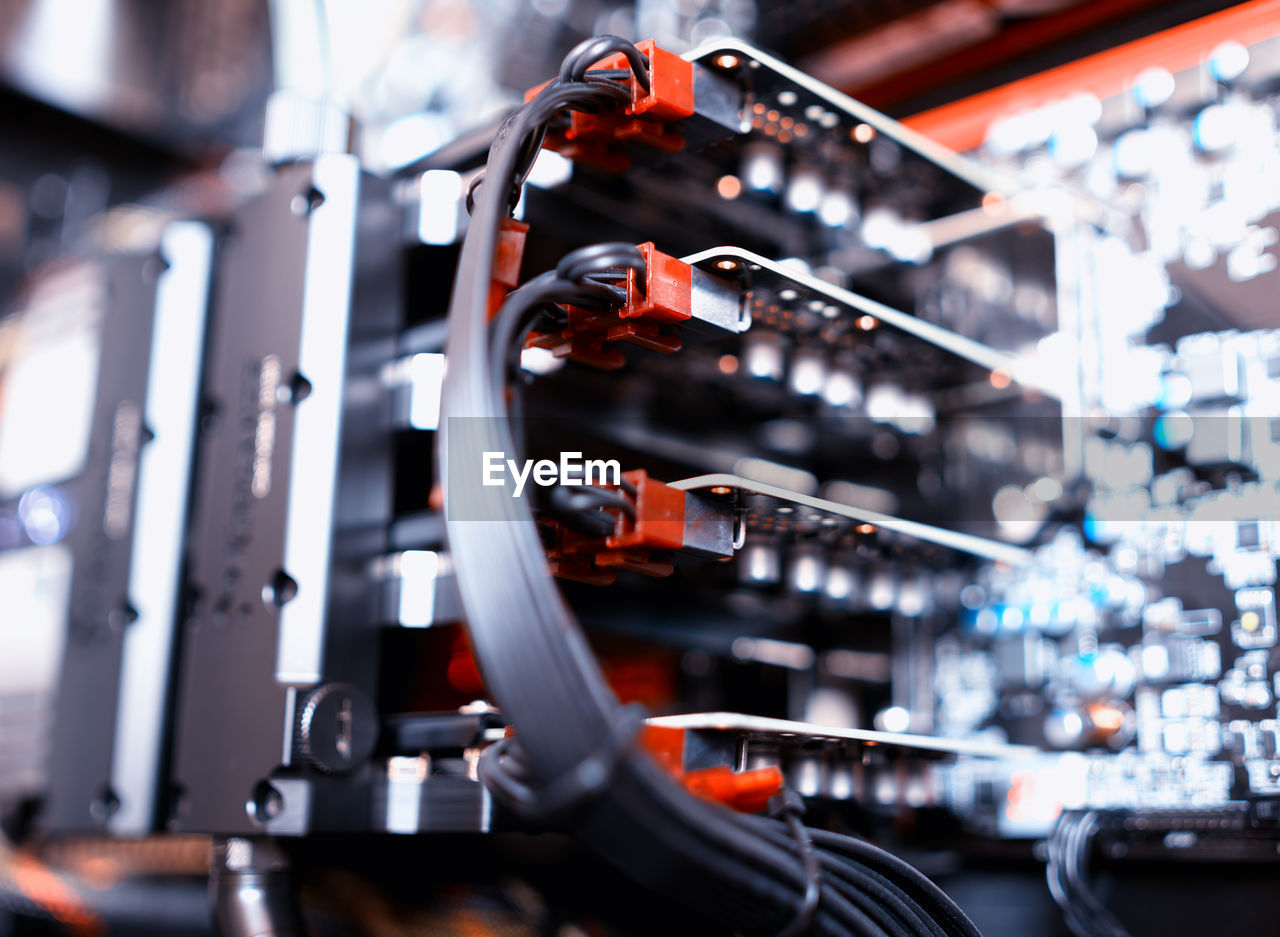 Low angle view of cables with machinery in factory