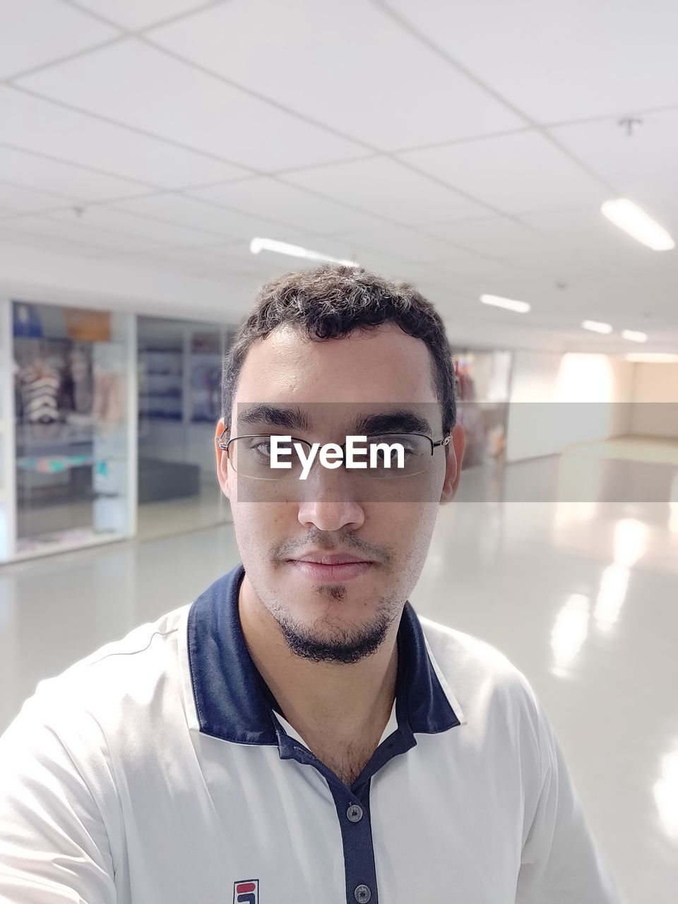 PORTRAIT OF A YOUNG MAN WITH EYEGLASSES