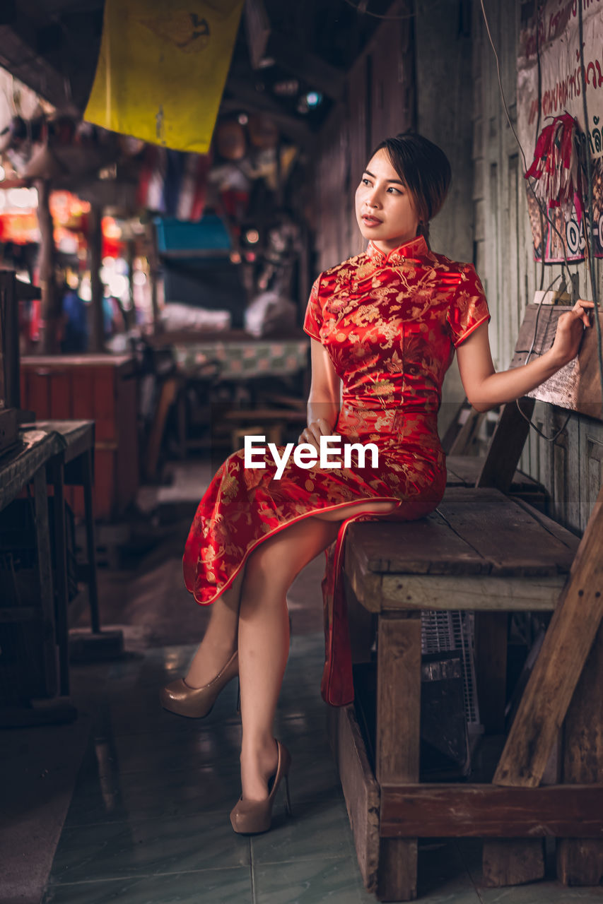 Young woman in traditional clothing sitting