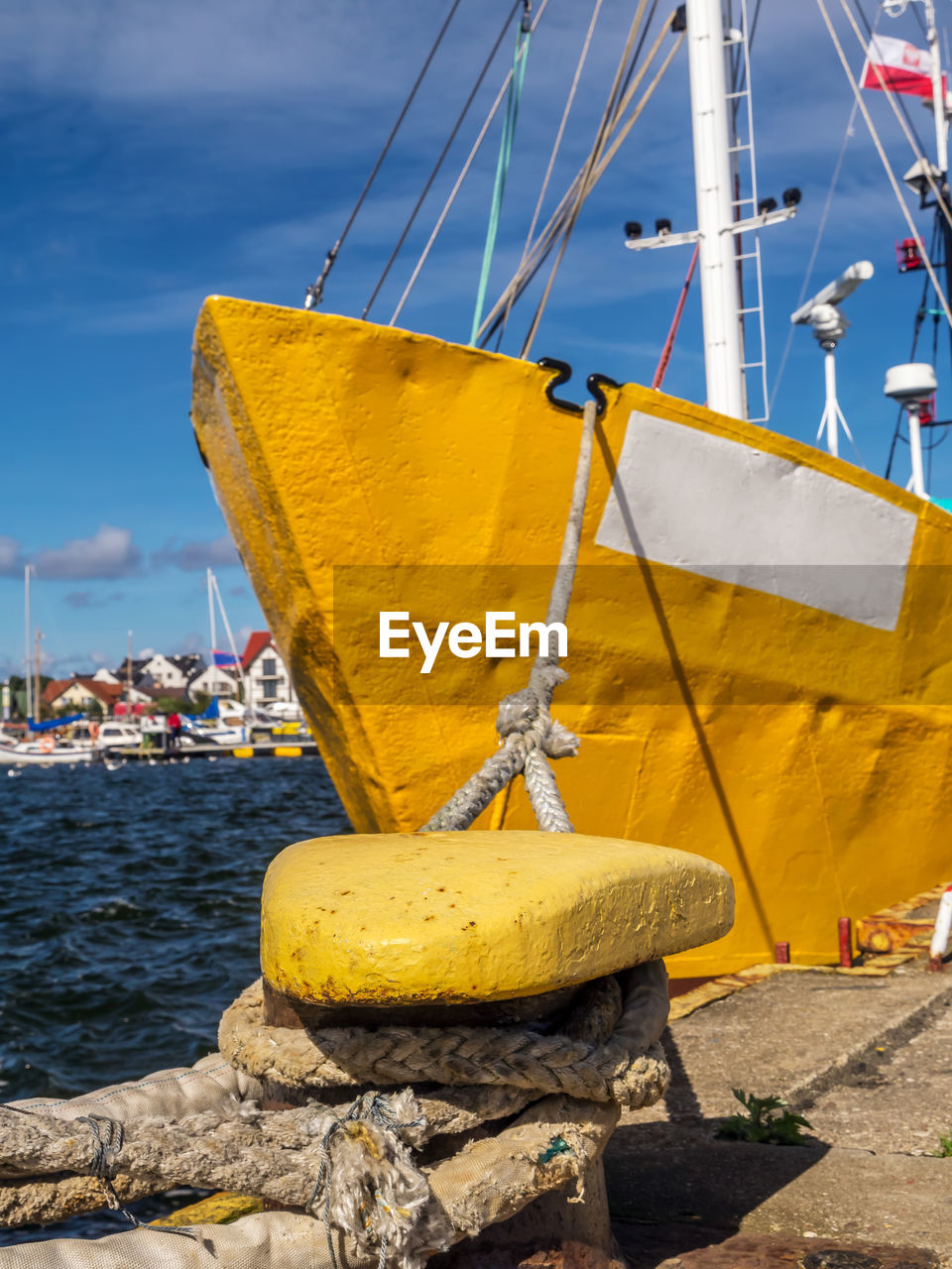 Yellow cutter berthed to the bollar at the harbour