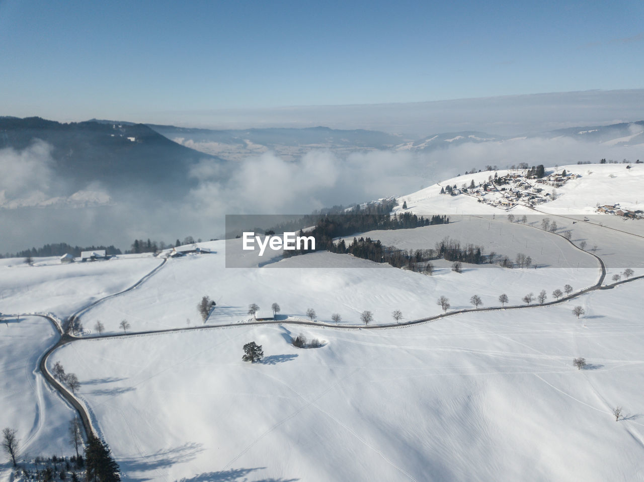 Scenic view of snow covered mountains against sky