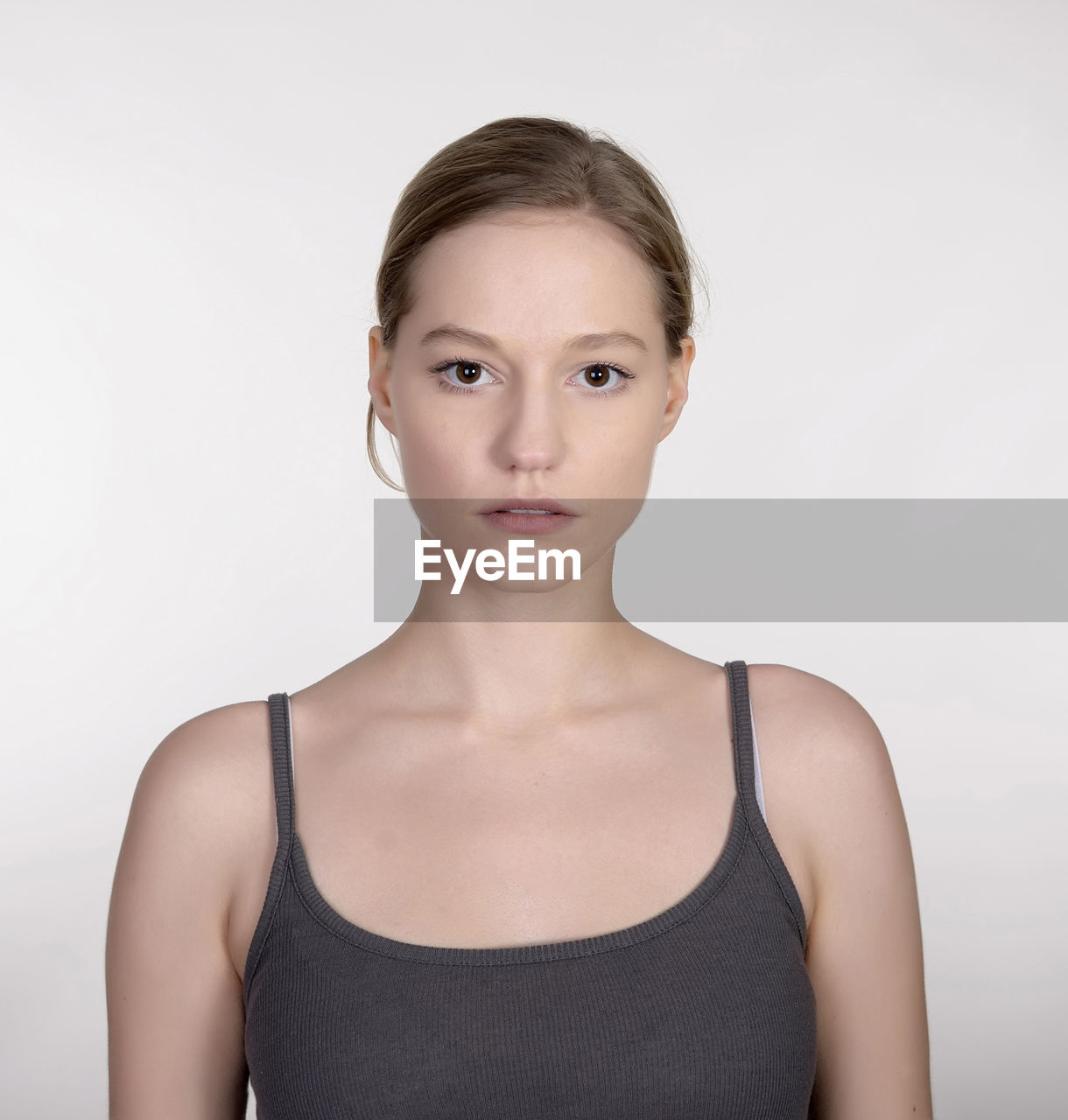 Portrait of beautiful young woman over white background