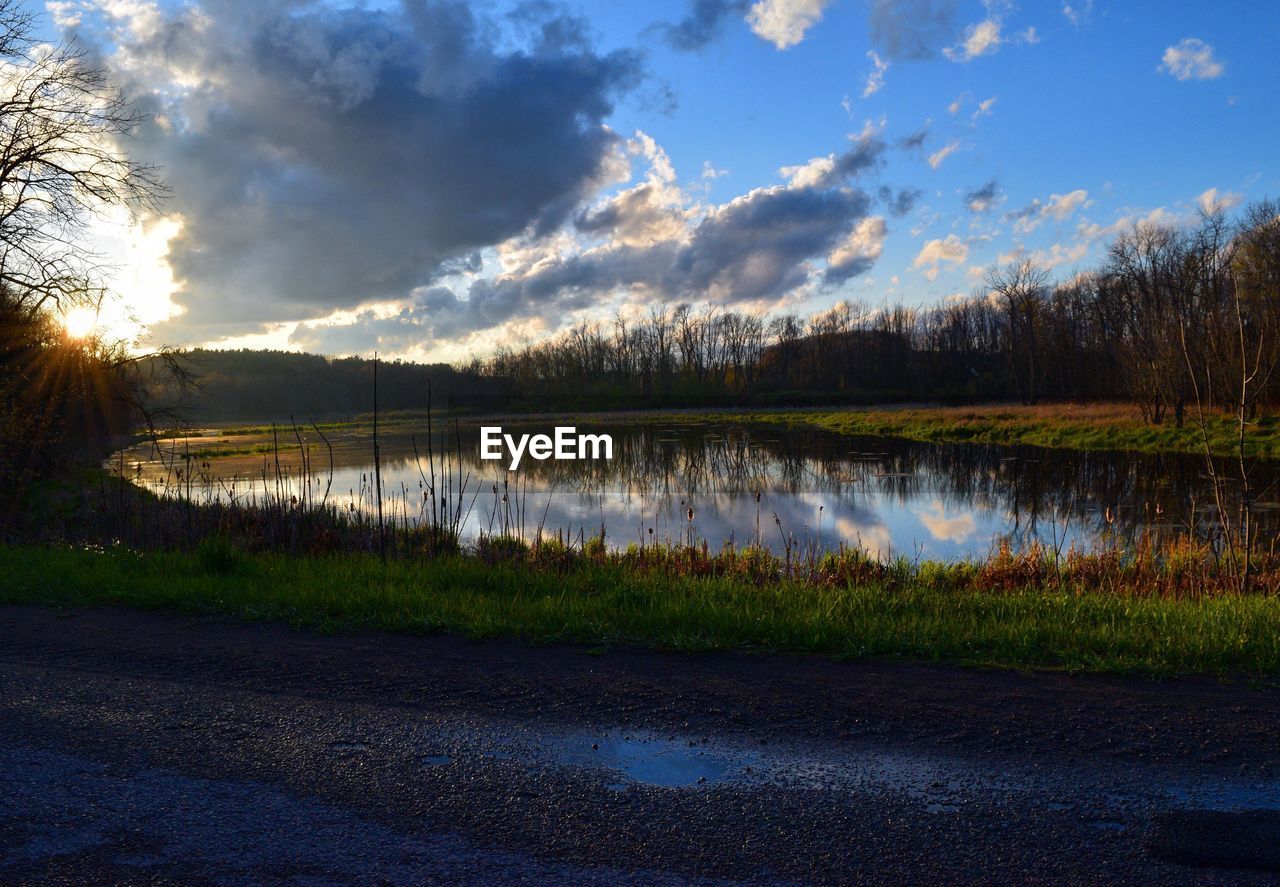 Scenic view of lake against cloudy sky