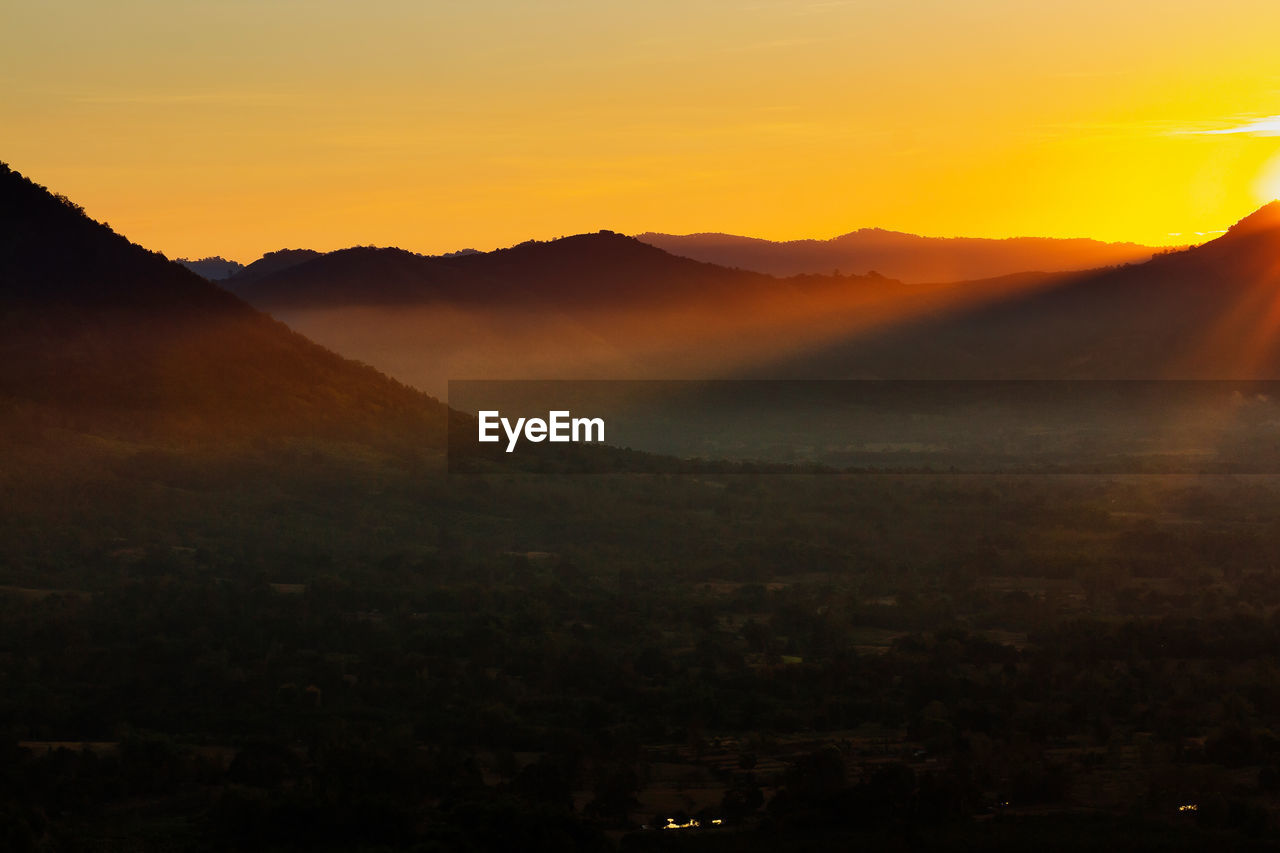 Scenic view of silhouette mountains against sky during sunset