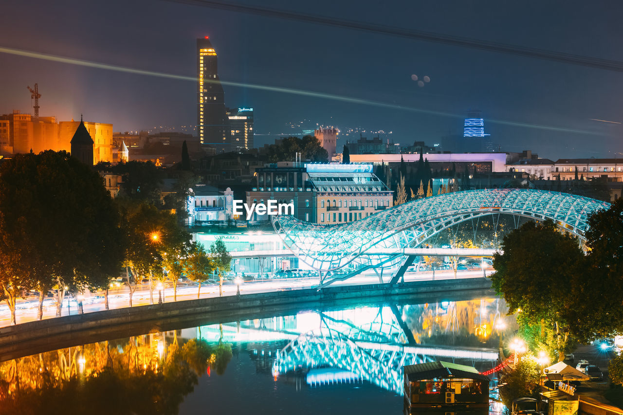 high angle view of illuminated bridge over river at night