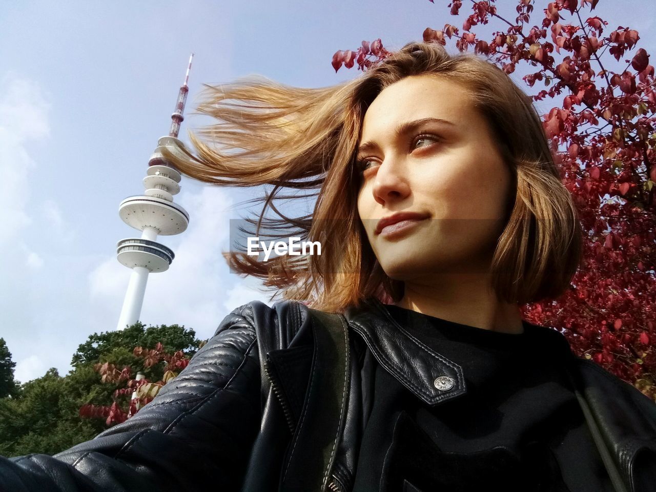 Beautiful woman in city against sky