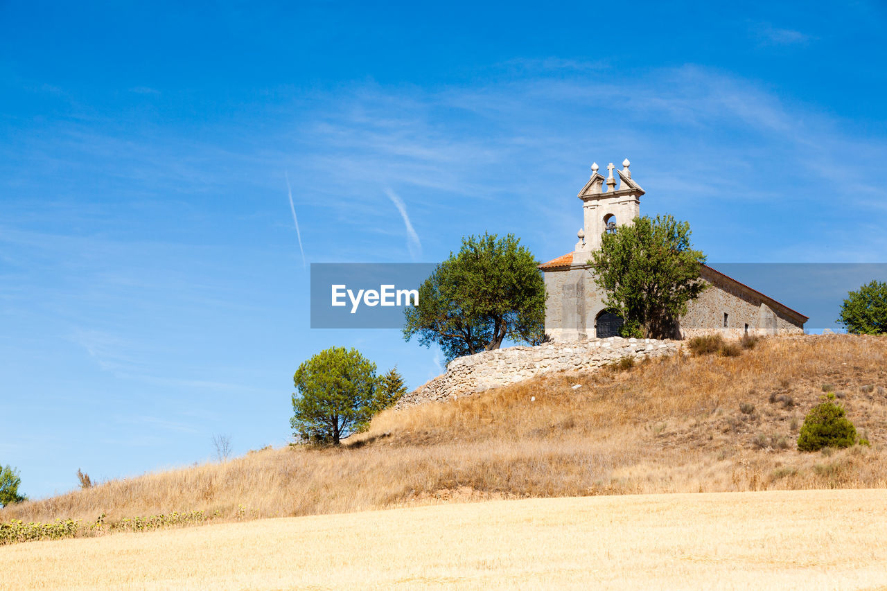 built structure on field against blue sky