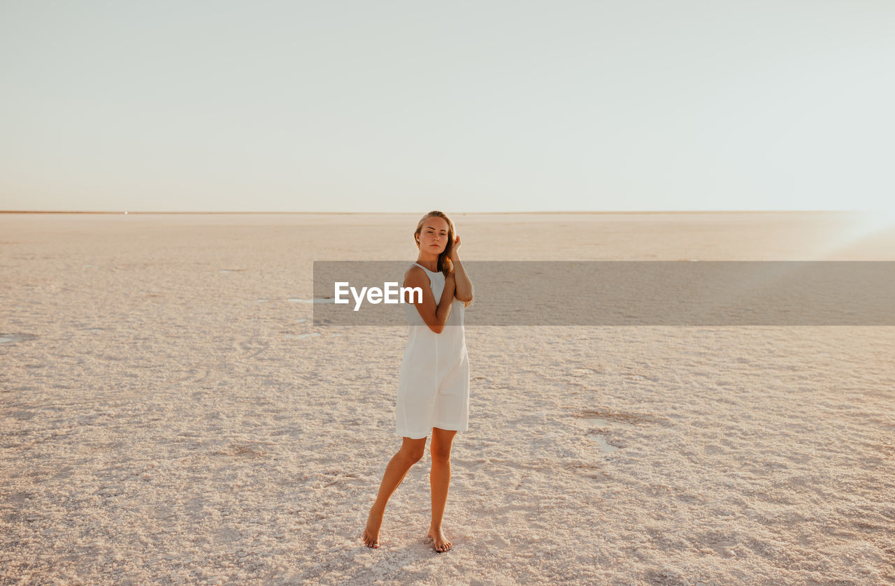 full length of woman standing at beach