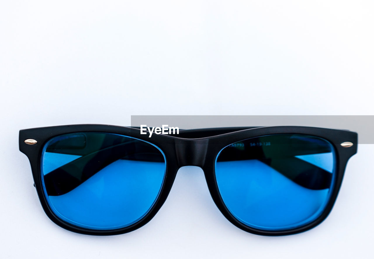 fashion, eyewear, glasses, azure, fashion accessory, cool attitude, sunglasses, aqua, cut out, single object, vision care, eyeglasses, protection, reflection, blue, white background, personal accessory, studio shot, personal protective equipment, brown, plastic, indoors, elegance, no people, close-up, black, security, luxury, wealth