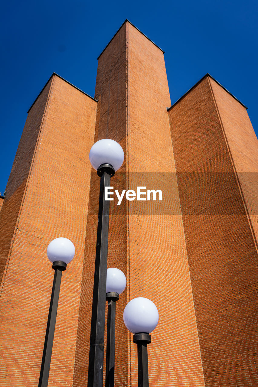 Low angle view of building against clear blue sky monument brutalism