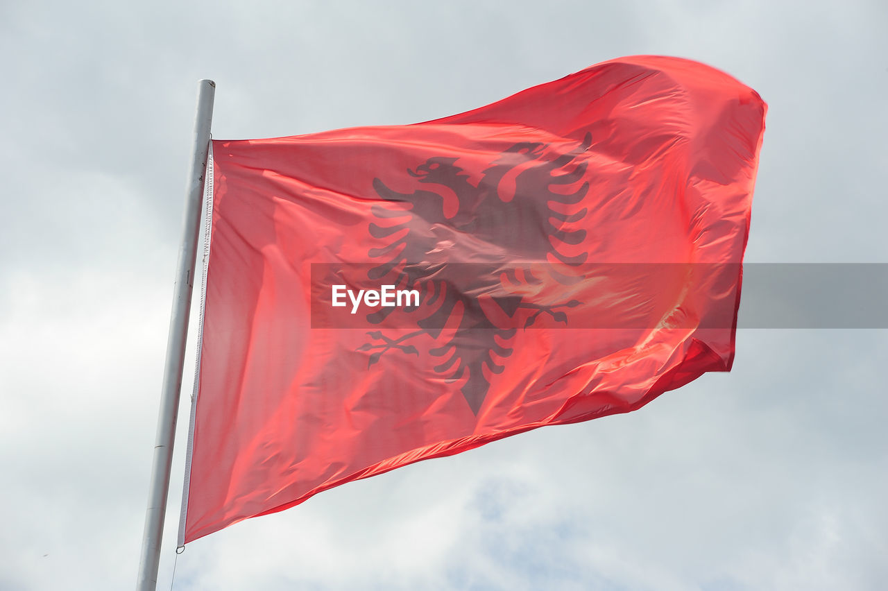 Low angle view of albania flag against sky