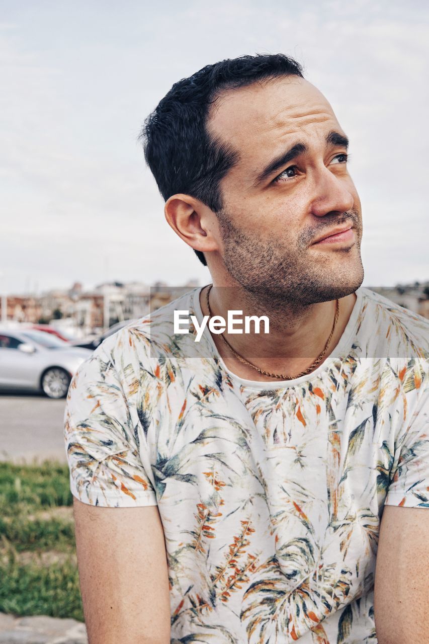 PORTRAIT OF HANDSOME YOUNG MAN LOOKING AWAY