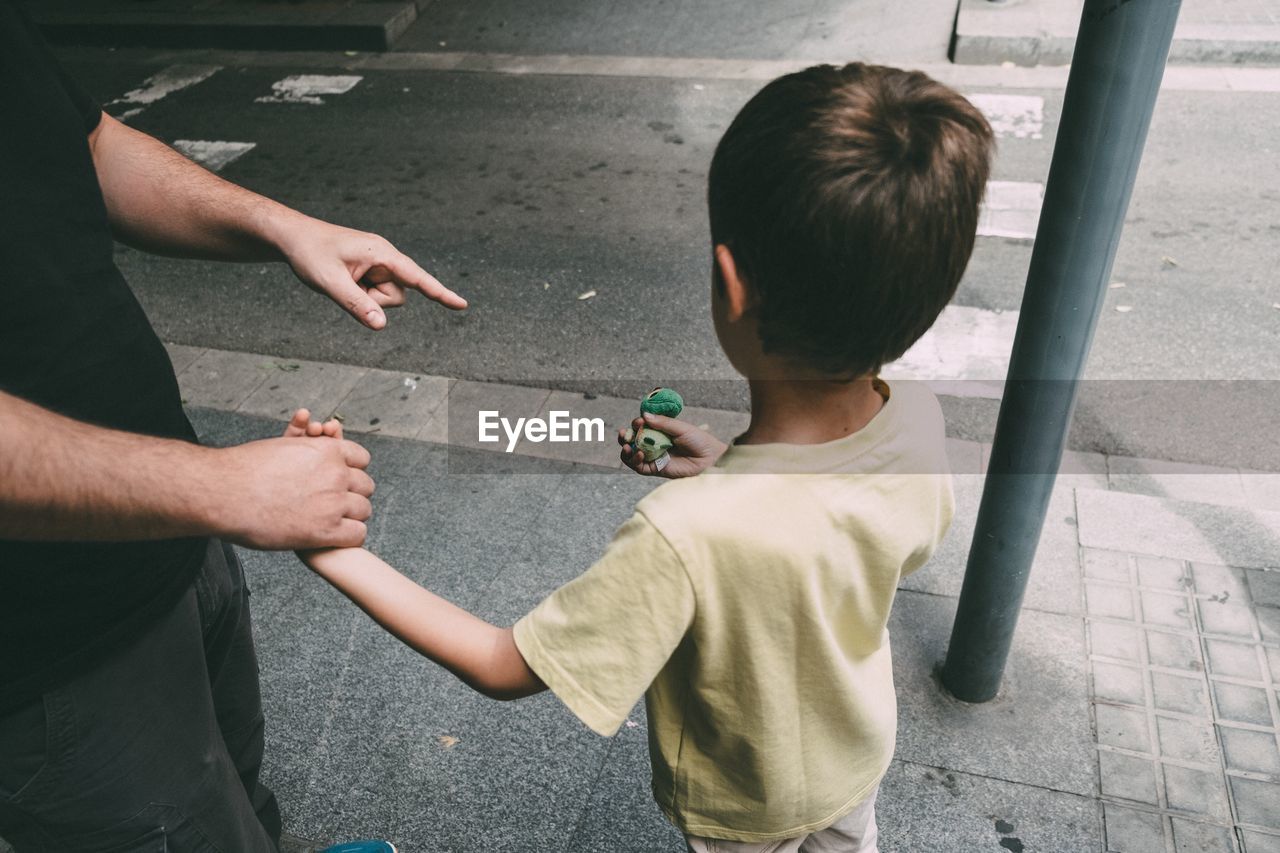 High angle view of father and son on street